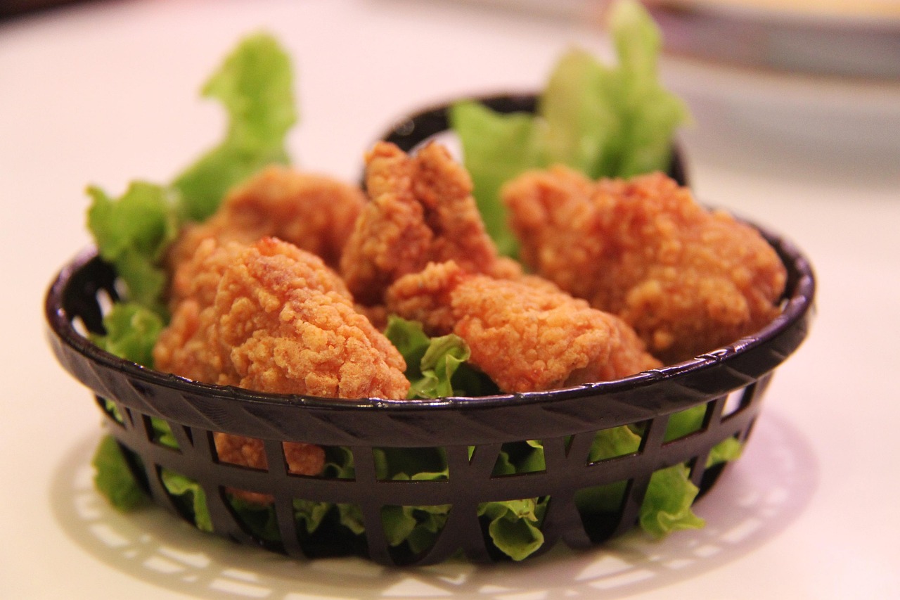 Crispy golden fried chicken pieces piled together